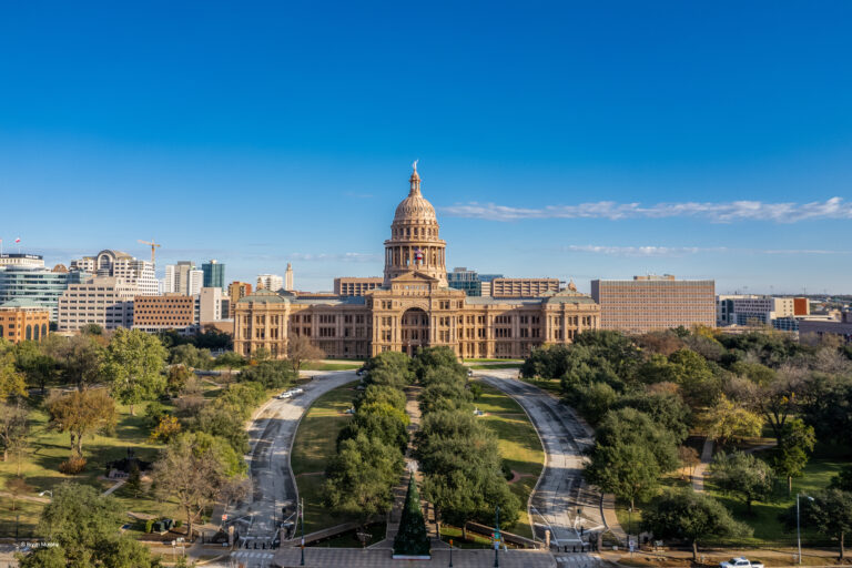 Texas State Capitol against a blue cloudy sky on a sunny day
